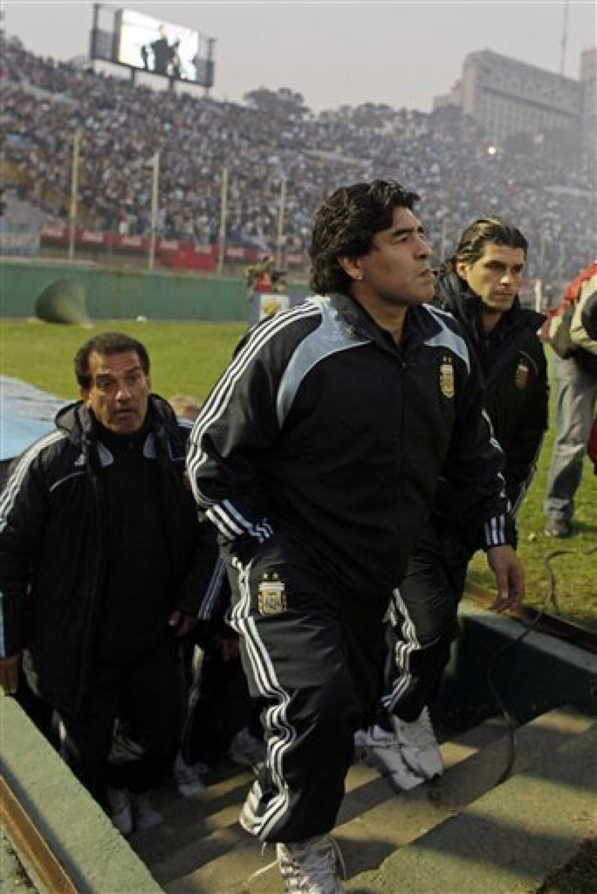 Argentina's coach Diego Maradona enters the field for a 2010 World Cup qualifying soccer match against Uruguay in Montevideo, Wednesday, Oct. 14, 2009. Argentina won 1-0. (AP Photo/Natacha Pisarenko)