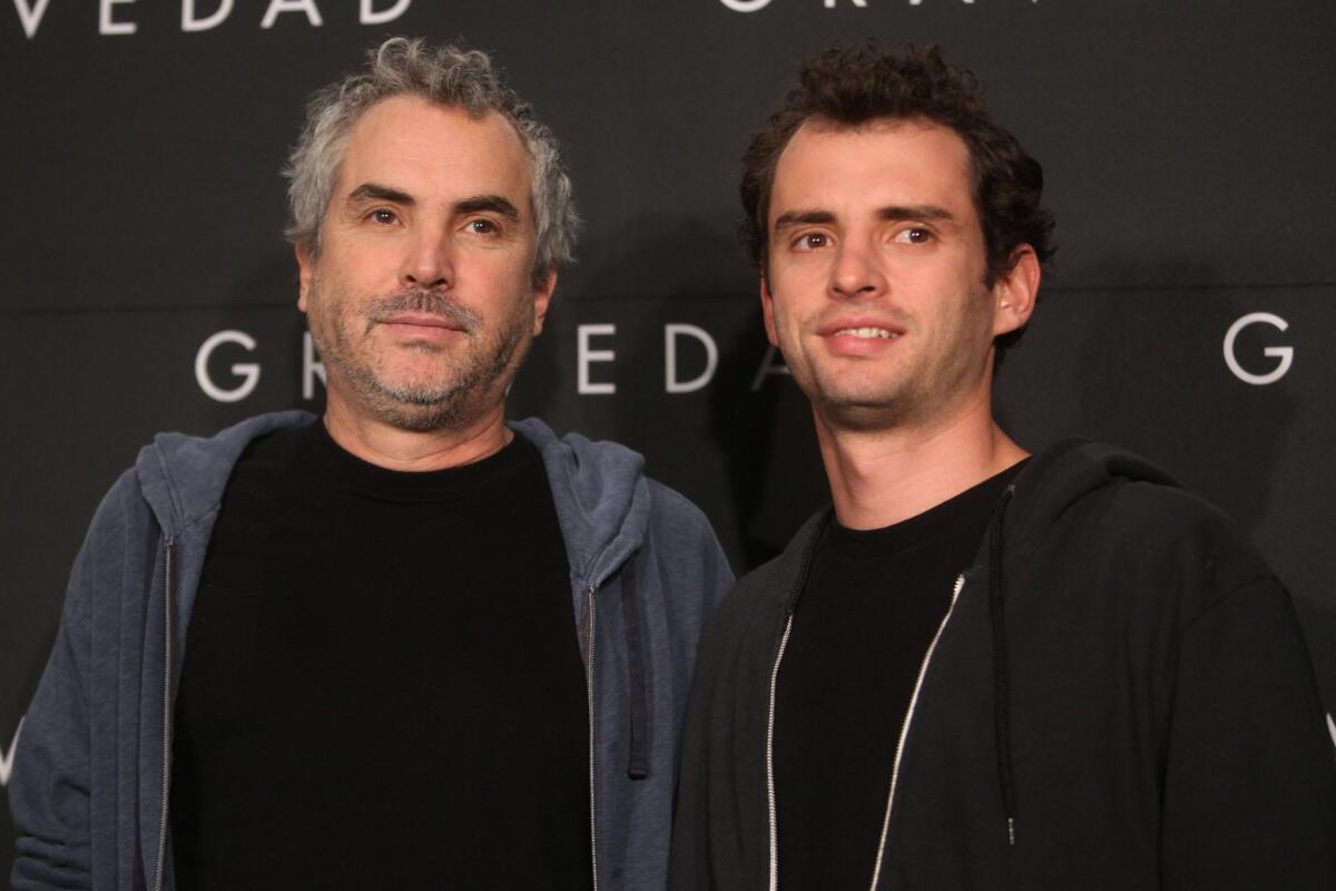 Alfonso Cuaron, director of "Gravity," participates with his son, Jonas, at a news conference in Mexico City.