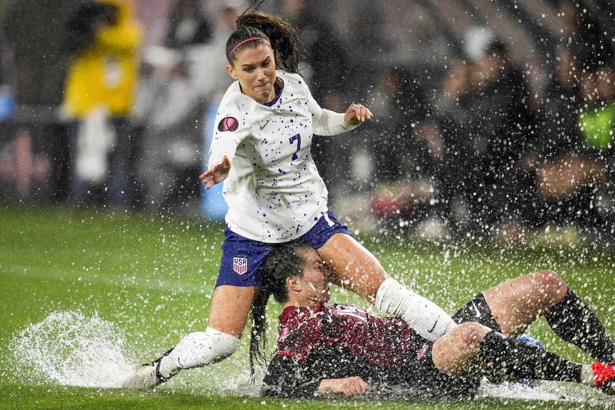 Alex Morgan of the U.S. collides with Canada’s Vanessa Gilles during Wednesday’s CONCACAF W Gold Cup semifinal.