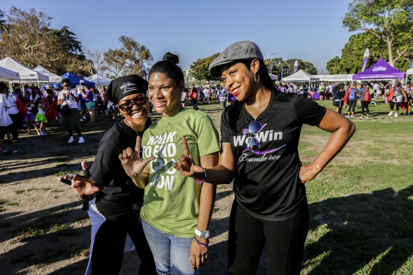 Tichina Arnold, right, representing her We Win Foundation arrives at Exposition Park with her sister Zenay Arnold (left) to take part in the Walk to End Lupus Now in Los Angeles.