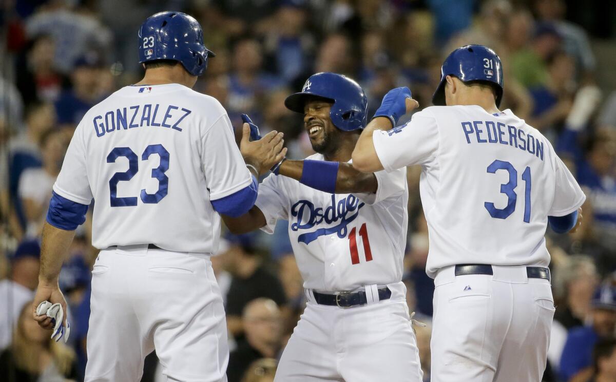 Dodgers shortstop Jimmy Rollins (11) celebrates his three-run home run against his former team, the Phillies, with Adrian Gonzalez and Joc Pederson.