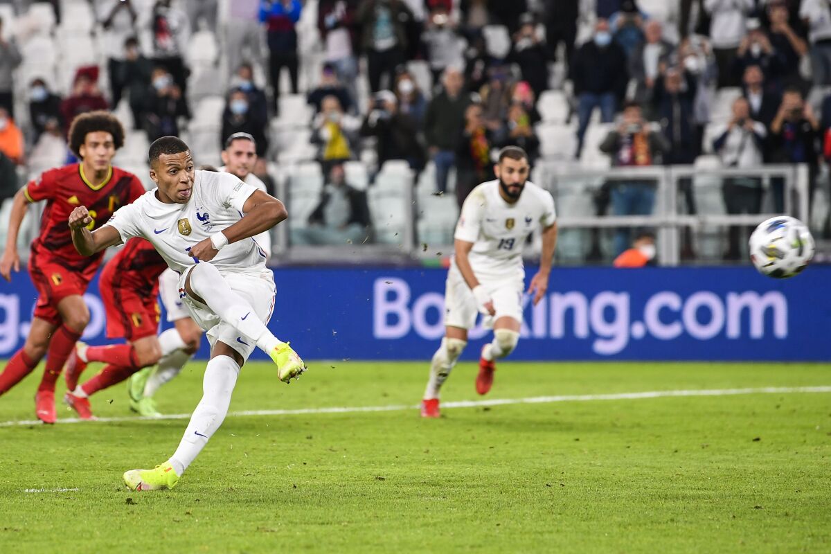 France's Kylian Mbappe scores his team's second goal from the penalty spot during the UEFA Nations League semifinal soccer match between Belgium and France at the Juventus stadium, in Turin, Italy, Thursday, Oct. 7, 2021. (Fabio Ferrari/LaPresse via AP)
