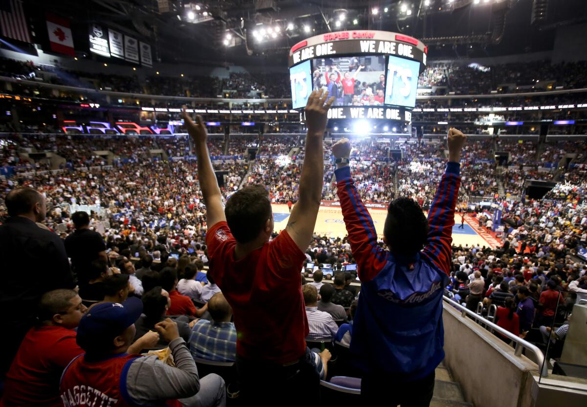 Fans show their support of the Los Angeles Clippers during their opening-round NBA playoff series against the Golden State Warriors. An Assembly candidate is proposing that the team move south to Orange County.