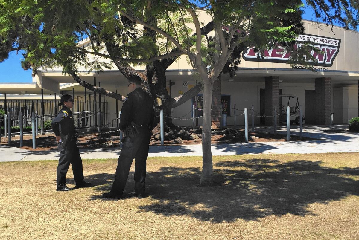 Police officers stand guard at Kearny High School in Linda Vista after a bomb threat was called into the school on Thursday morning and prompted a lockdown.