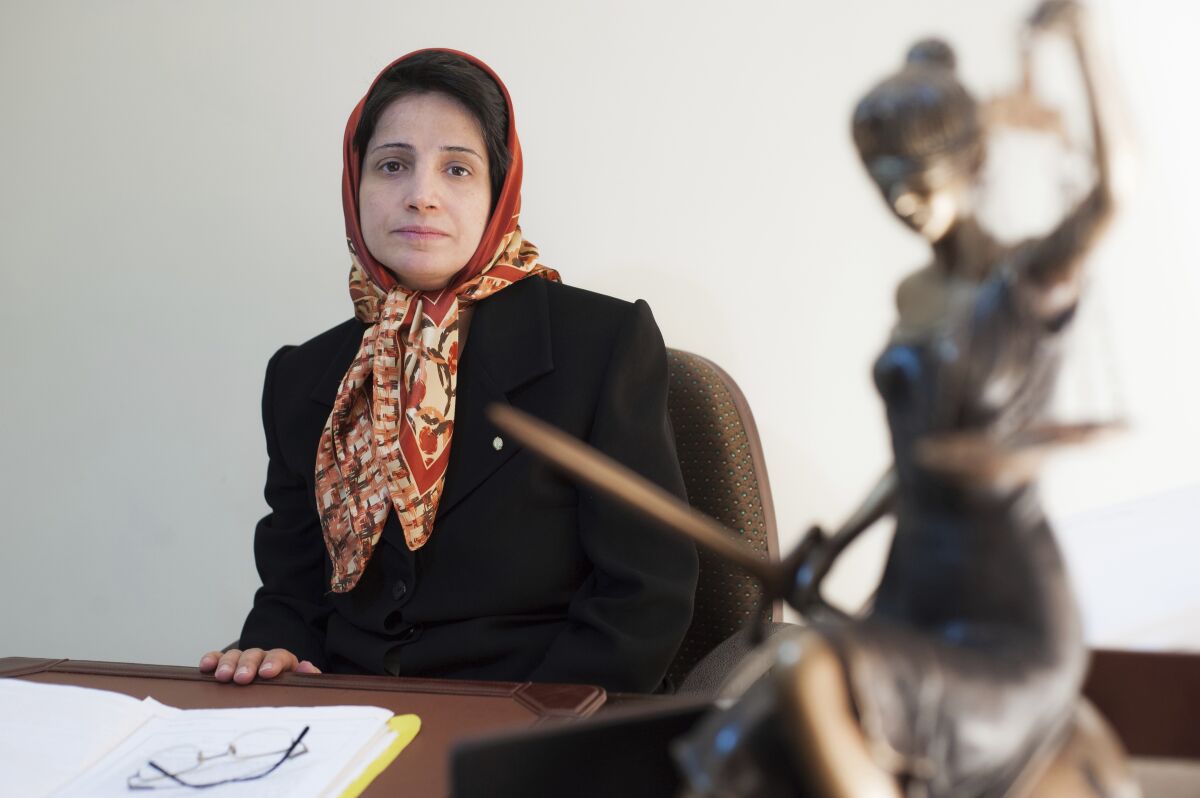 FILE - In this Nov. 1, 2008 file photo, Iranian human rights lawyer Nasrin Sotoudeh, poses for a photograph in her office in Tehran, Iran. Reza Khandan, the husband of Sotoudeh told The Associated Press on Thursday, Aug. 13, 2020, that his wife began a hunger strike Tuesday seeking the release of political prisoners. Khandan said he feared it would exacerbate her chronic gastrointestinal and foot problems. Sotoudeh, a mother of two, was arrested in 2018 on charges of collusion and propaganda against the system and eventually was sentenced to 38 years in prison and 148 lashes. (AP Photo/Arash Ashourinia, File)