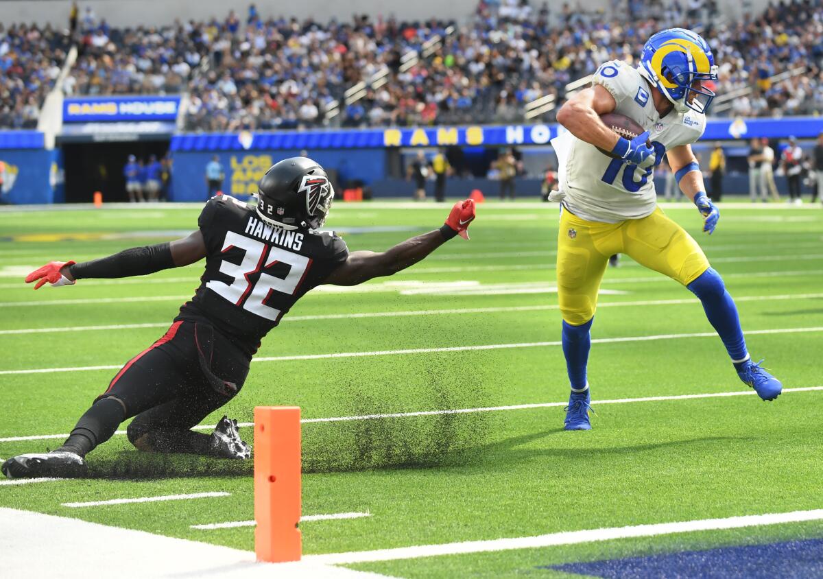 Rams receiver Cooper Kupp runs past Falcons safety Jaylinn Hawkins on a touchdown catch.