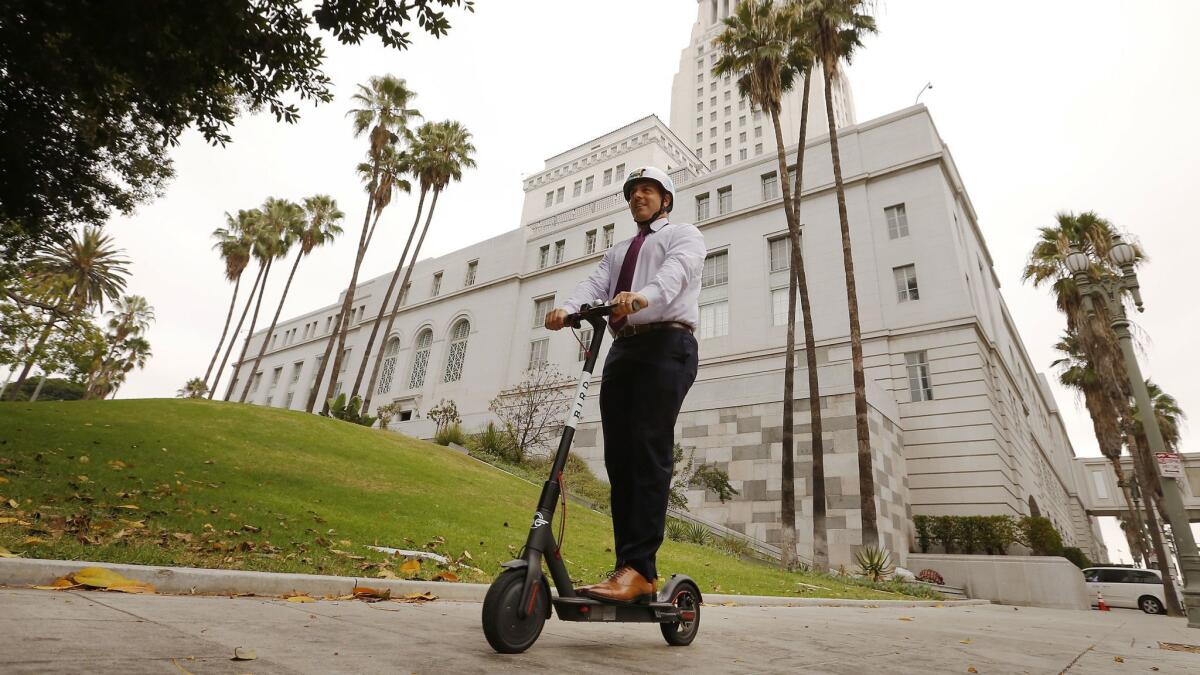 Los Angeles City Councilman Joe Buscaino rides a Bird rental scooter around City Hall on Sept. 4.
