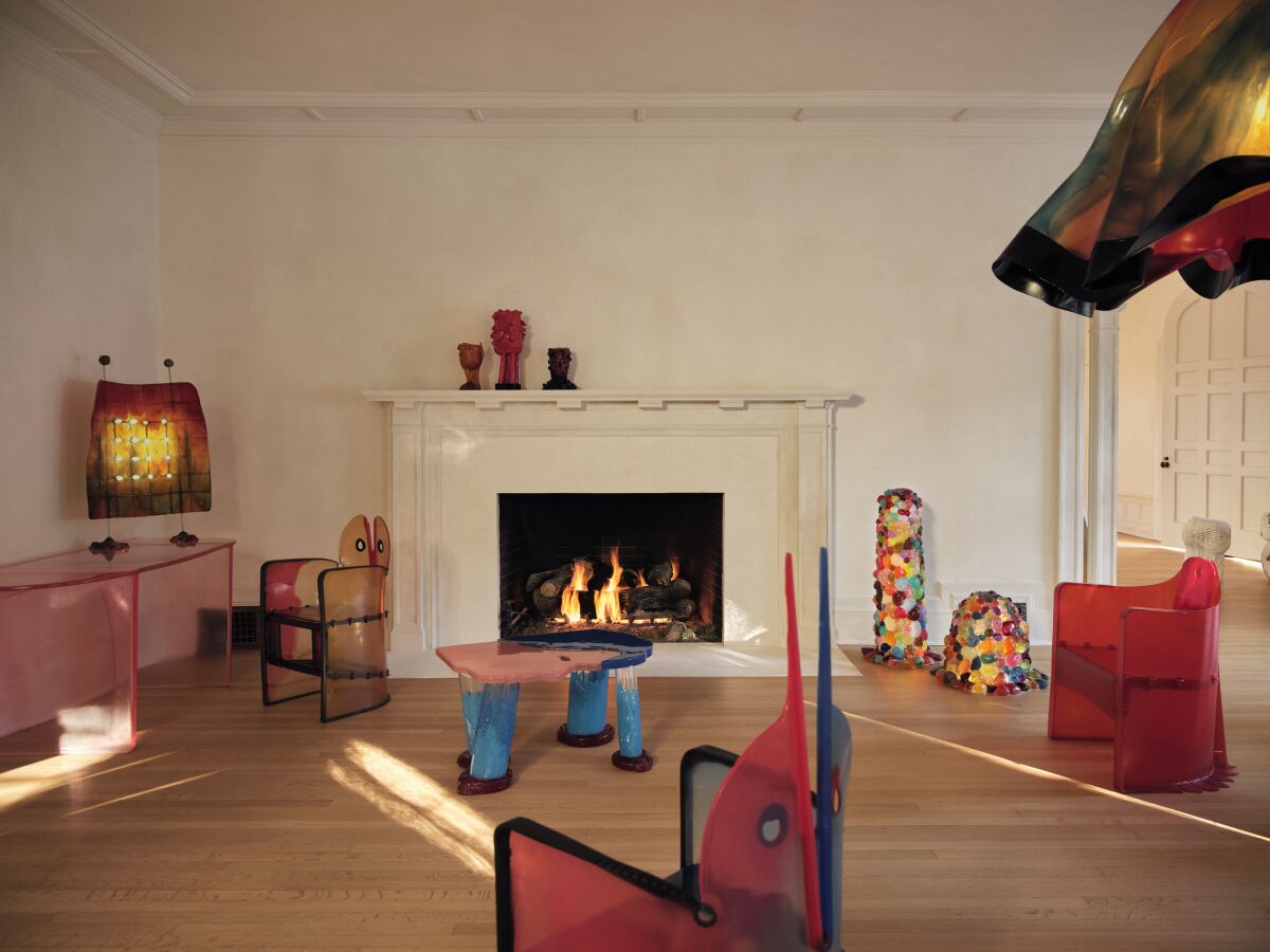 A living room furnished with bright, unusually shaped pieces.