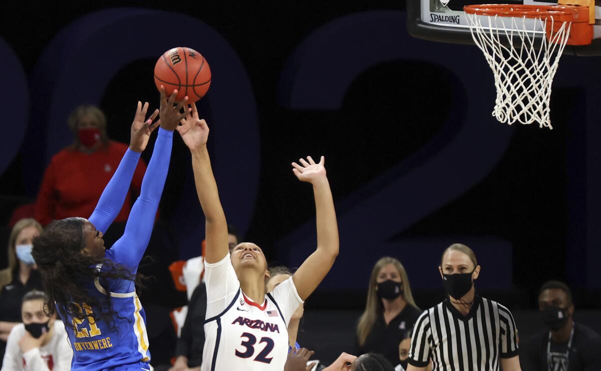 UCLA's Michaela Onyenwere goes up for a shot as Arizona's Lauren Ware defends March 5, 2021, in Las Vegas.