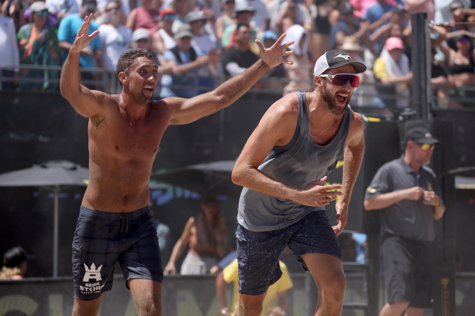 Trevor Crabb, left, and Theo Brunner celebrate their AVP Manhattan Beach Open win