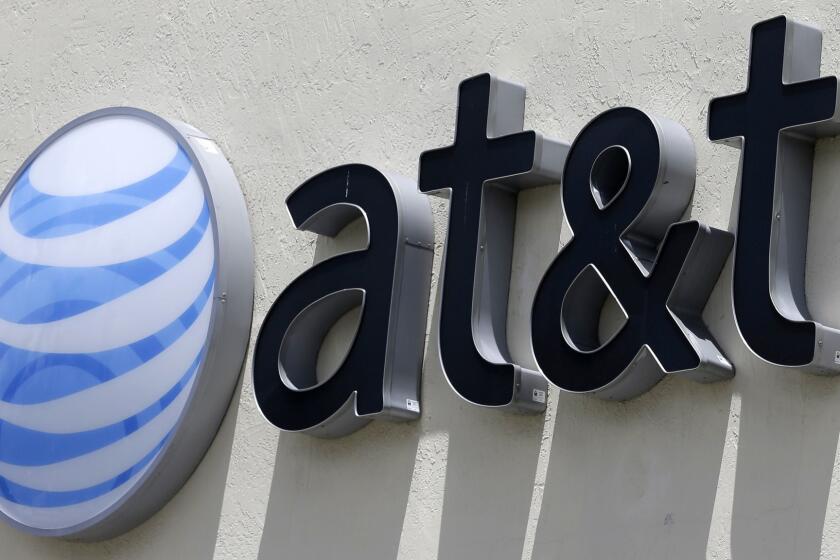 FILE - This July 27, 2017, file photo shows an AT&T logo at a store in Hialeah, Fla. AT&T is launching a new streaming service incorporating networks from the Time Warner company it just bought for $81 billion. Thursday, June 21, announcement comes just days after AT&T closed its Time Warner deal. (AP Photo/Alan Diaz, File)