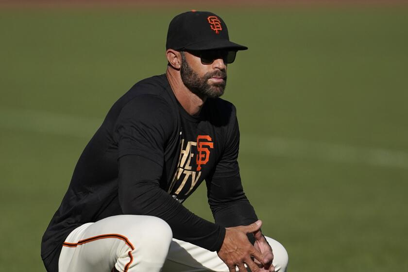 San Francisco Giants manager Gabe Kapler watches players during a baseball practice.
