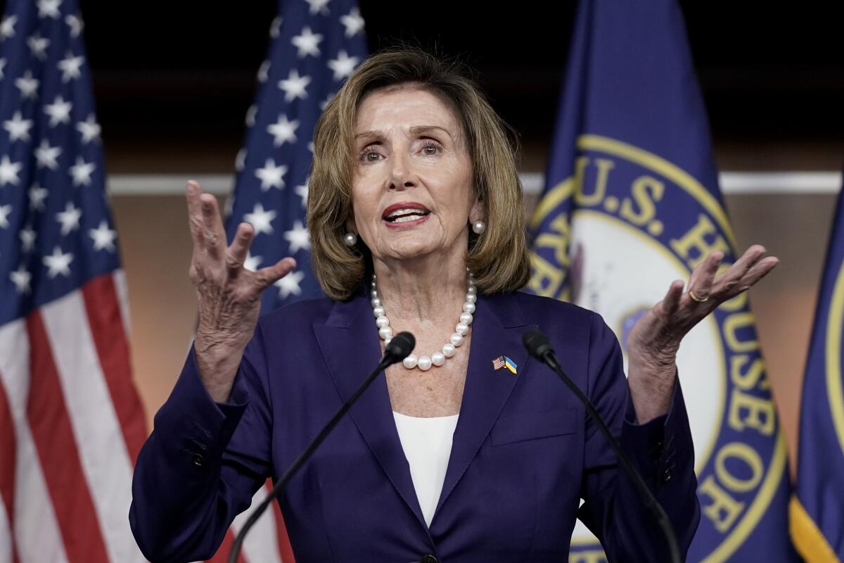 Speaker of the House Nancy Pelosi gestures with her hands as she speaks 