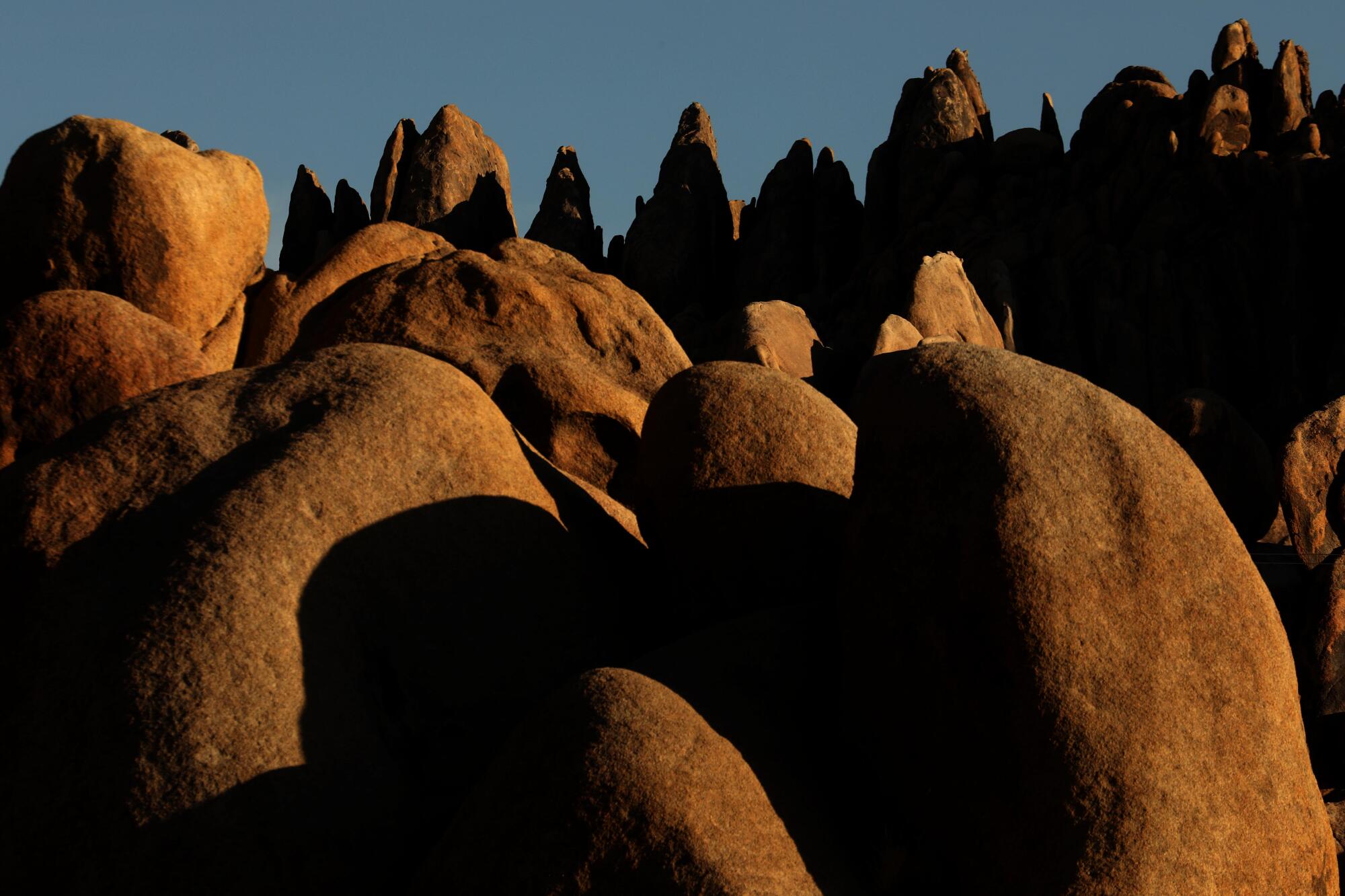 Rock formations bathed in golden light in the Alabama Hills National Scenic Area