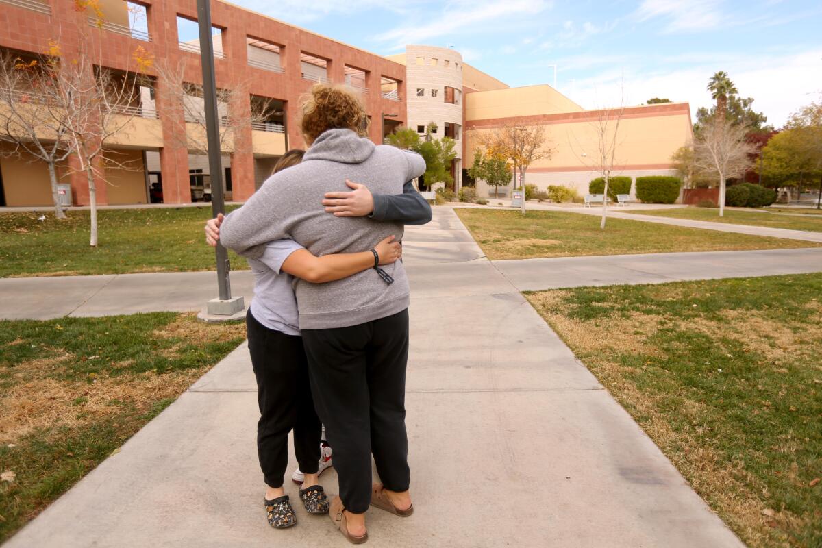 Three UNLV students give a group hug