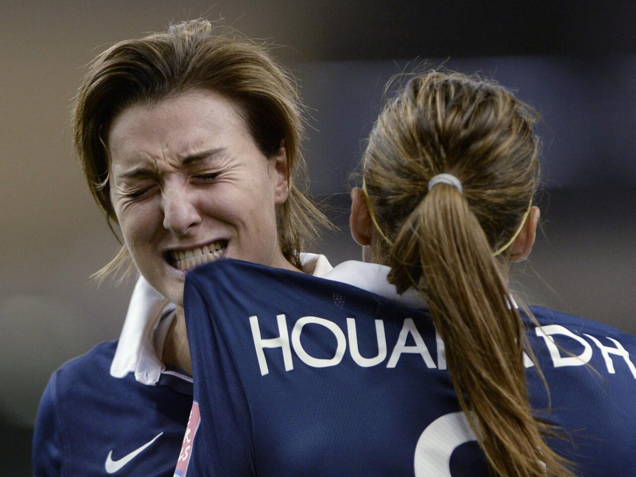 France's Claire Lavogez, left, reacts after missing a shot against Germany during the penalty-kick shootout in a quarterfinal match in the FIFA Women's World Cup soccer tournament, Friday, June 26, 2015, in Montreal, Canada. (Ryan Remiorz/The Canadian Press via AP)