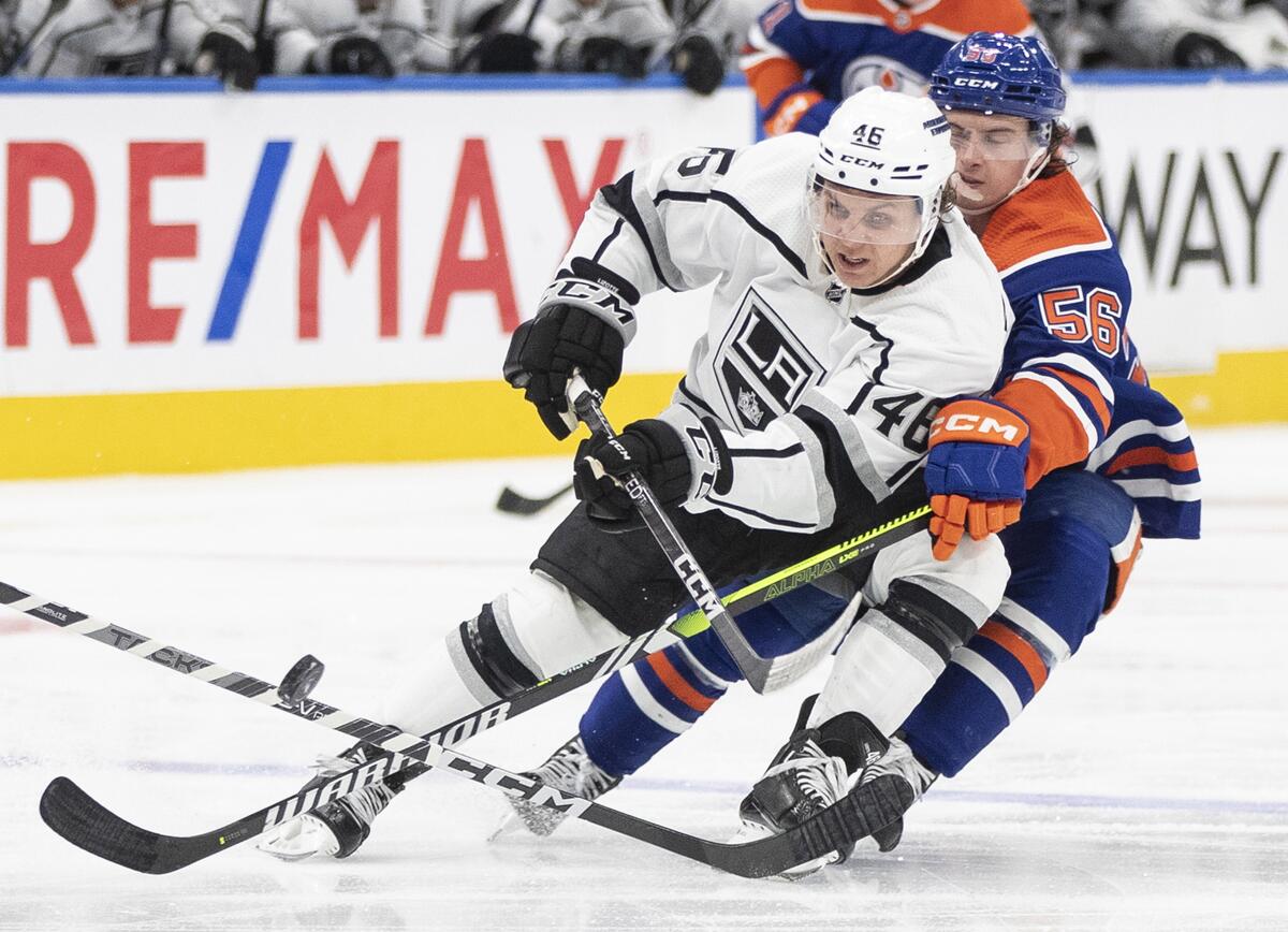 Los Angeles Kings' Blake Lizotte (46) and Edmonton Oilers' Kailer Yamamoto (56) battle for the puck