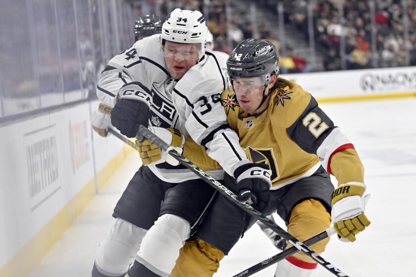 Los Angeles Kings right wing Arthur Kaliyev (34) and Vegas Golden Knights defenseman Zach Whitecloud.