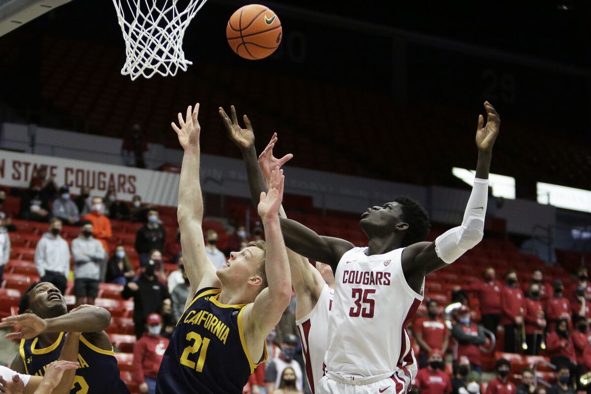 California forward Lars Thiemann (21) and Washington State forward Mouhamed Gueye (35) go after a rebound during the first half of an NCAA college basketball game, Saturday, Jan. 15, 2022, in Pullman, Wash. (AP Photo/Young Kwak)