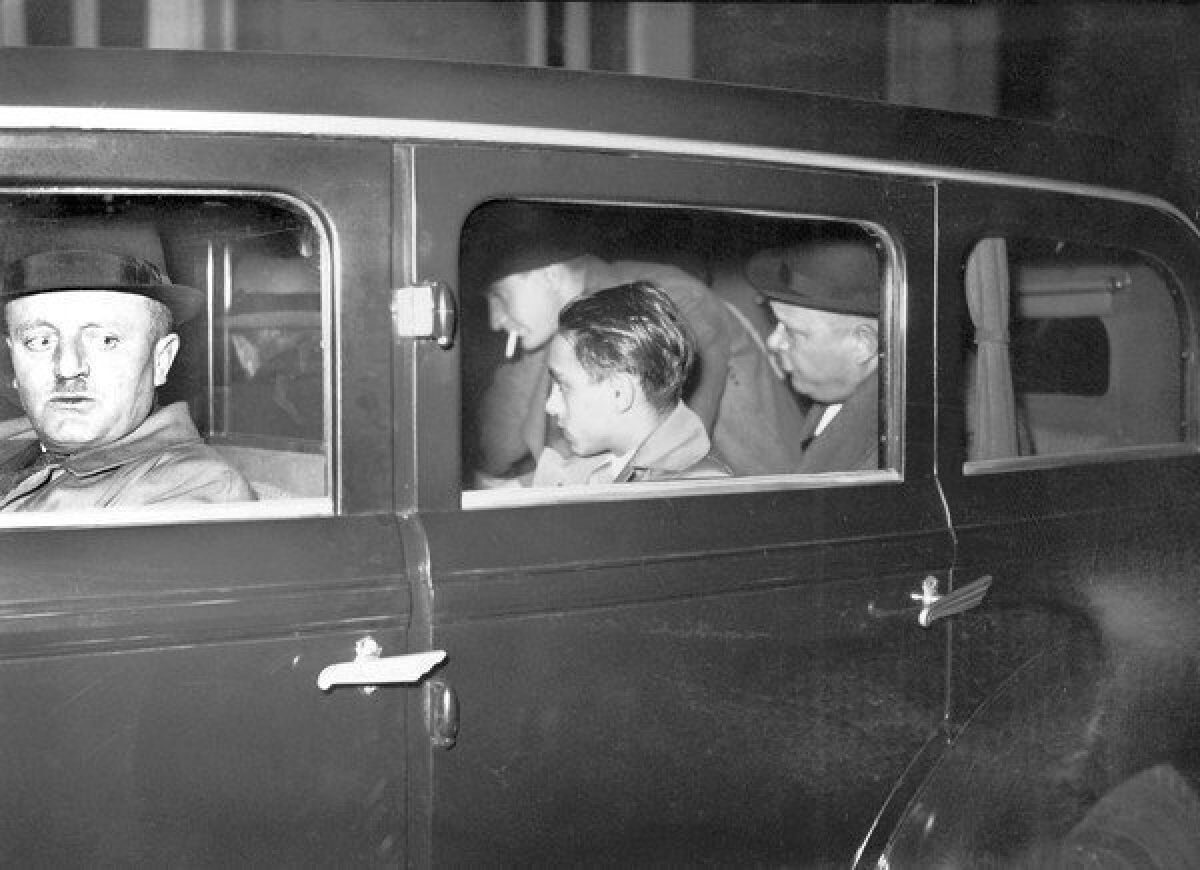 Herschel Grynszpan is escorted by French policemen Dec. 2, 1938, to Paris court.