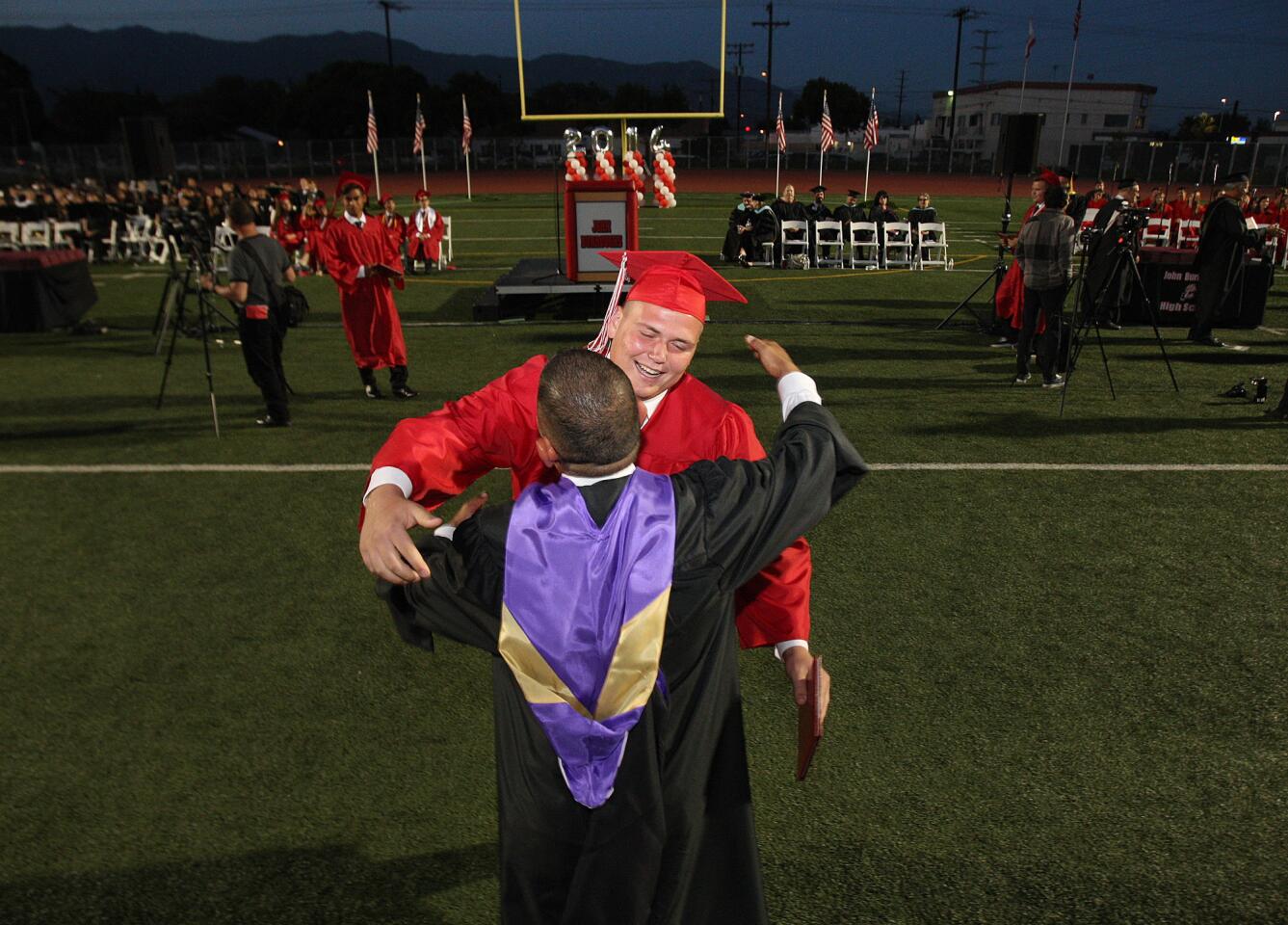 Graduate Jacob Pentland hugs school Principal John Paramo after graduating at the Burroughs High School graduation on Thursday, May 29, 2014.