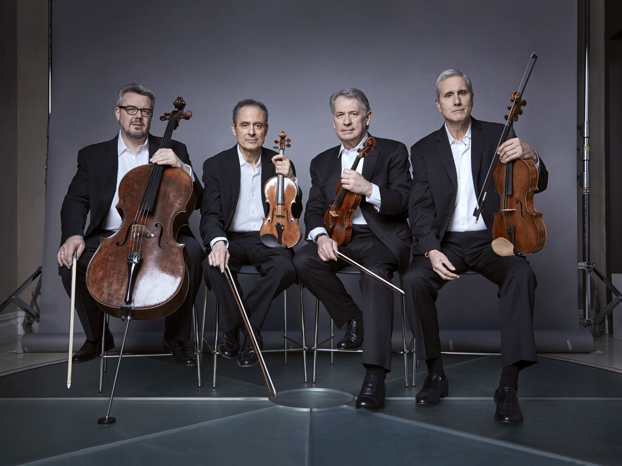 Emerson Quartet musicians pose with their instruments.
