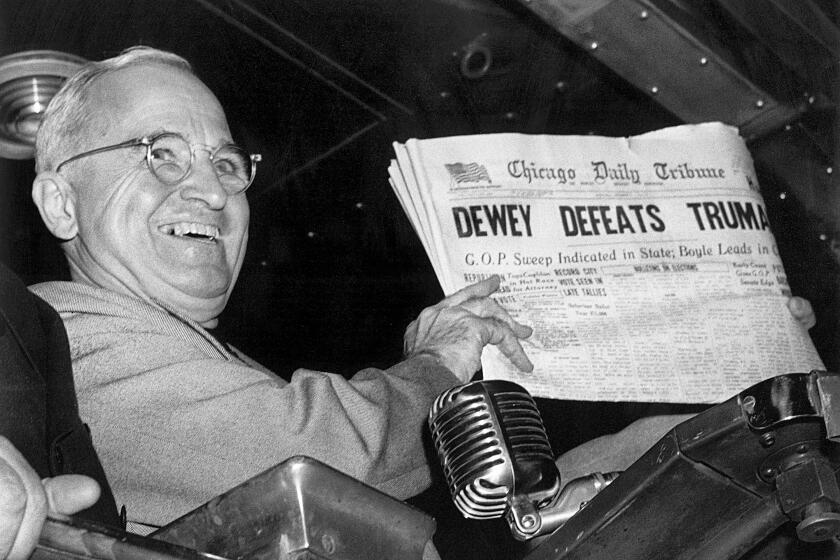 ARCHIVO - En esta foto de archivo del 4 de noviembre de 1948, el presidente Harry S. Truman en la estación Union de St. Louis sostiene una edición del día de las elecciones del Chicago Daily Tribune, que –basándose en los primeros resultados– anunciaba erróneamente "Dewey derrota a Truman". (AP Foto/Byron Rollins, Archivo)