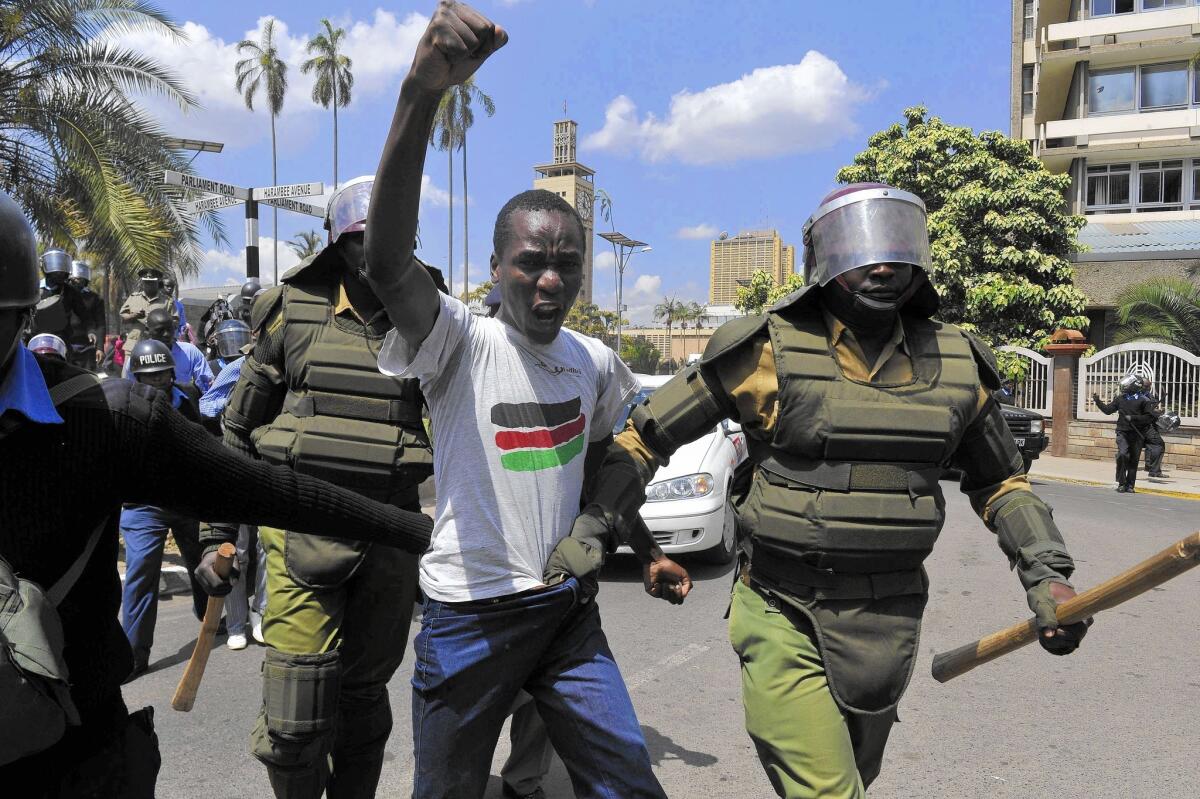 Kenyan police arrest a demonstrator Dec. 18 who was protesting an anti-terrorism law that places restrictions on journalists and broadly targets Somali refugees.