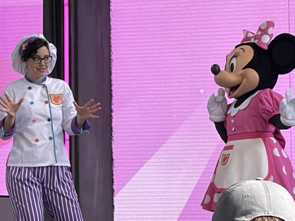 A chef confers with Minnie Mouse during “Confection Purrfection with the SuperKitties.”