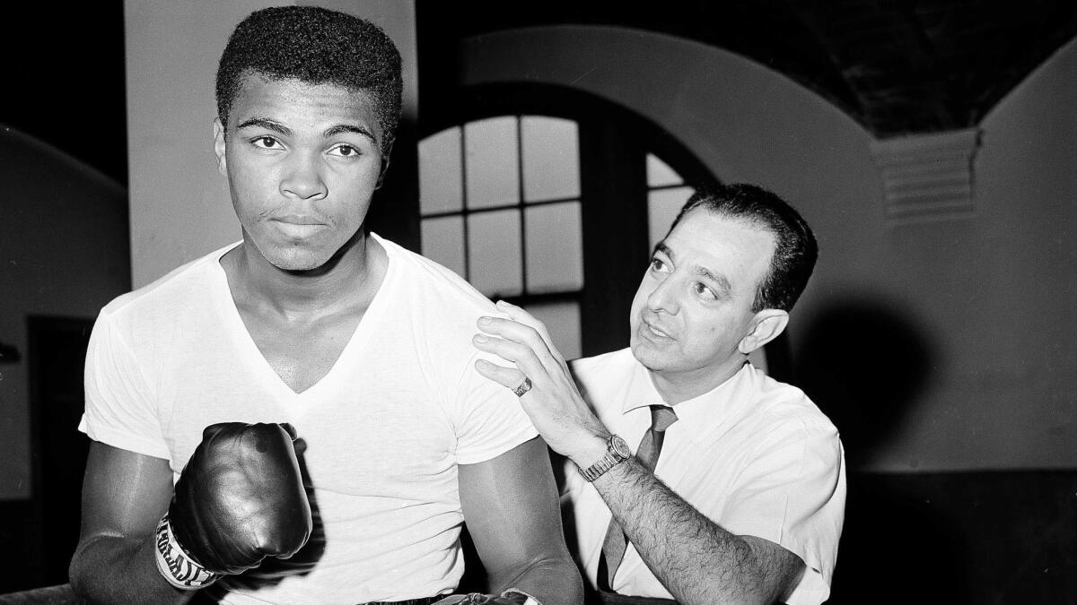 Boxer Muhammad Ali is seen with his trainer, Angelo Dundee, at City Parks Gym in New York on Feb. 8, 1962.