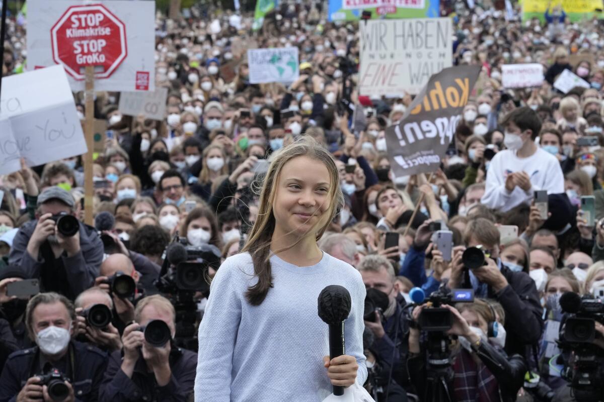FILE - In this Friday, Sept. 24, 2021 file photo, Swedish climate activist Greta Thunberg stands onstage during a Fridays for Future global climate strike in Berlin, Germany. The annual Nobel Peace Prize, to be announced Oct. 8, shines the brightest of lights on the person or group thought to have done most to promote peace. But guessing who it will be is just a stab in the dark. Potential recipients this year include Belarus opposition leader Sviatlana Tsikhanouskaya, Russian opposition leader Alexei Navalny, Swedish climate activist Greta Thunberg — or organizations and groups such as the World Health Organization, Reporters Without Borders and Black Lives Matter. (AP Photo/Markus Schreiber, file)