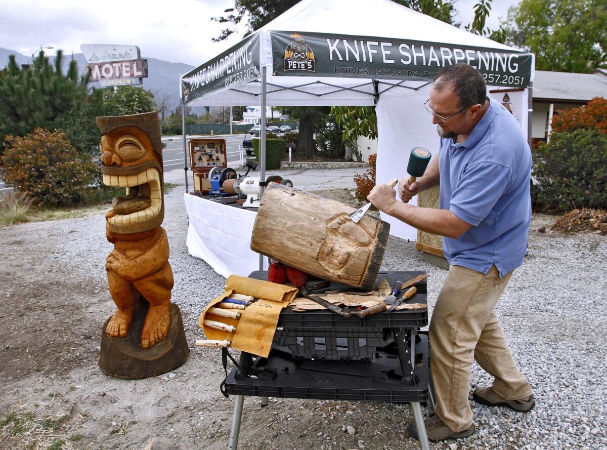 When no customers are around, Peter Gick carves out some tikis at his knife sharpening stand on Foothill Blvd. at Briggs Ave. in his home town of La Crescenta on Wednesday, Feb. 26, 2014. Gick also has his stand at the Glendale Farmer's Market on Thursdays.
