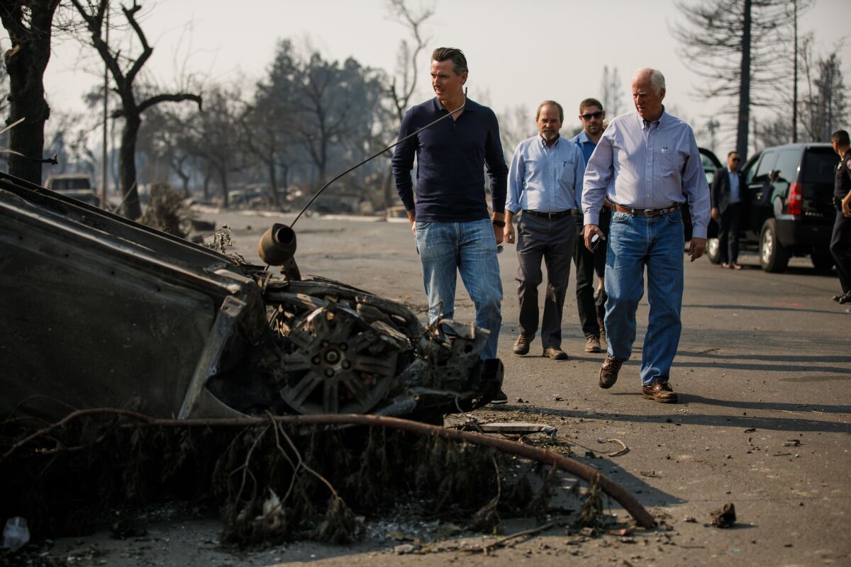 Lt. Gov. Gavin Newsom, from left, Santa Rosa Mayor Chris Coursey and Congressman Mike Thompson survey fire damage.