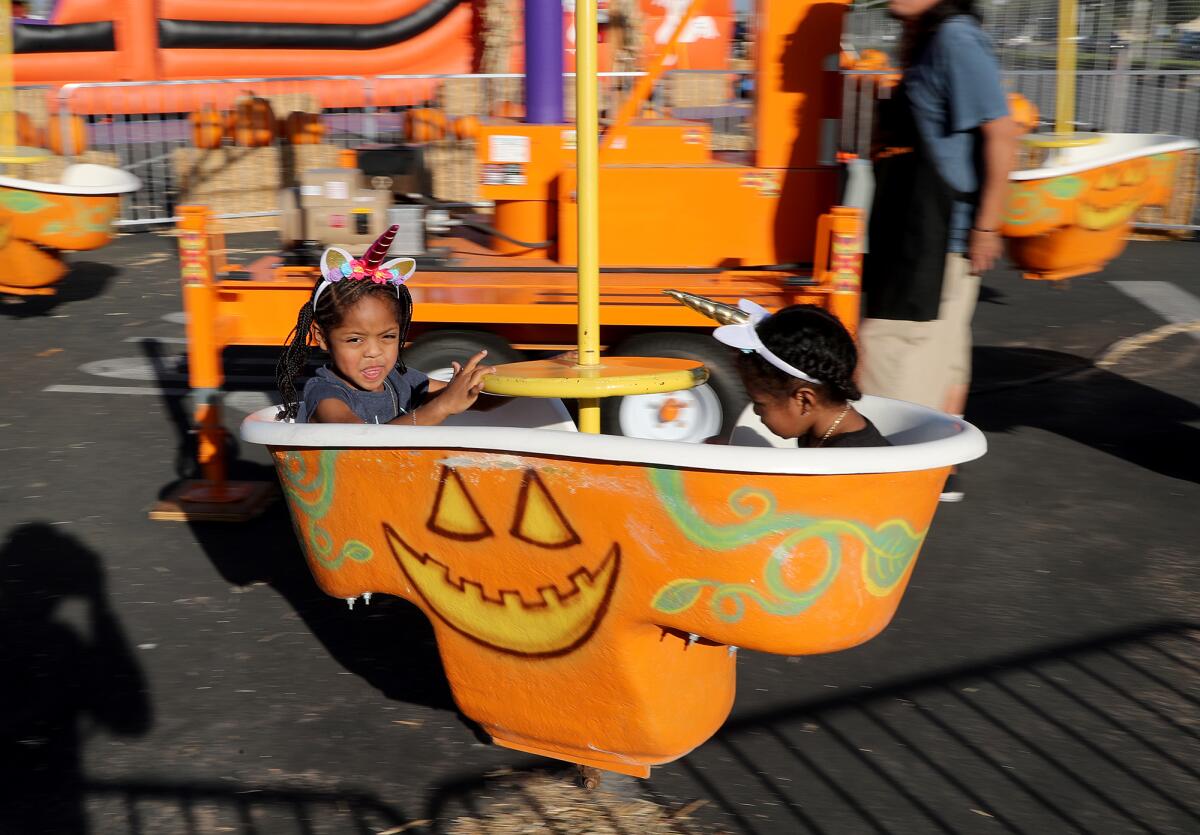 Zoe McClain and her sister, Keilani enjoy a ride during Seasonal Adventures at the O.C. fairgrounds.