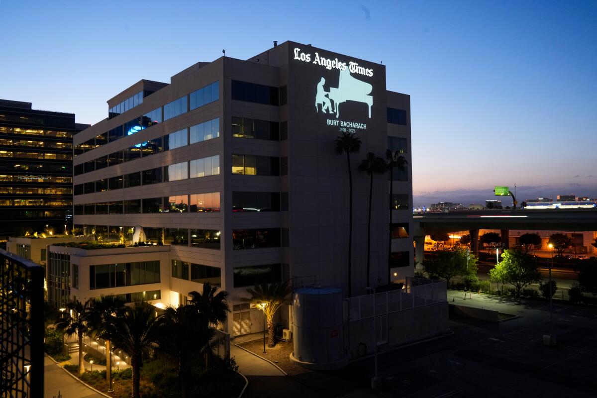 A projection of a man playing piano is shown on the side of the  Los Angeles Times Building in El Segundo, California