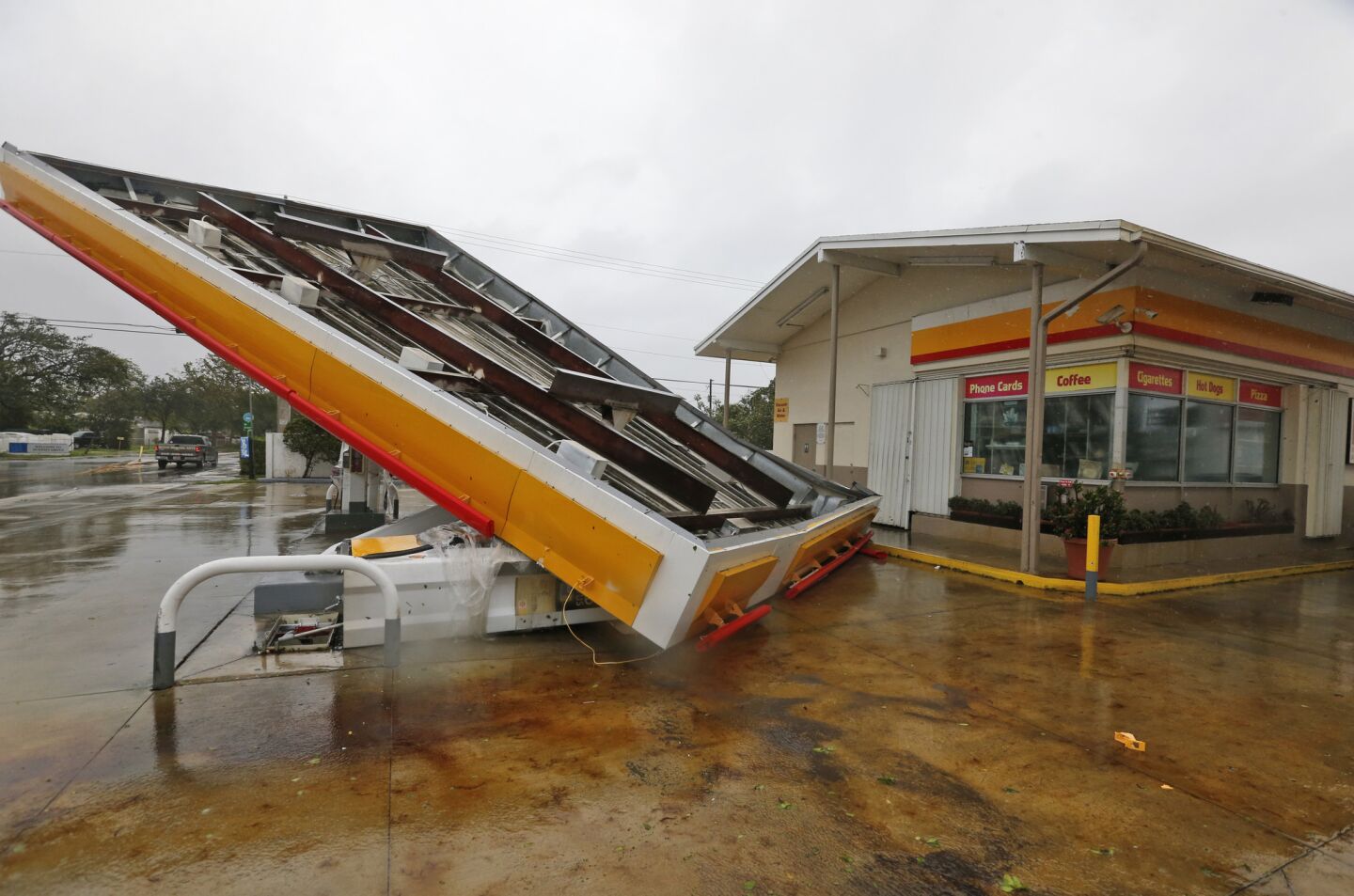 The metal canopy at a gasoline station is overturned by high winds brought on by Hurricane Irma.