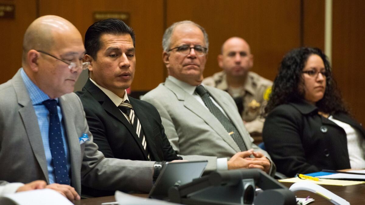 Defense attorney William Seki, from left, Los Angeles Police Department Officer Rene Ponce, defense attorney Ira Salzman and LAPD Officer Irene Gomez listen to testimony during a preliminary hearing earlier this year.