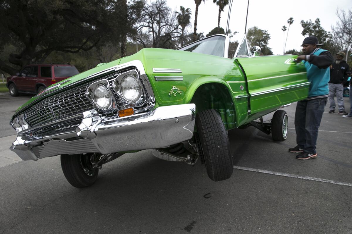 ‘Tee’ sale del vehículo Chevy Impala 1963 en el parque Fairmount donde se juntan los miembros del Ultimate Riders Car Club. (Robert Gauthier/Los Angeles Times).