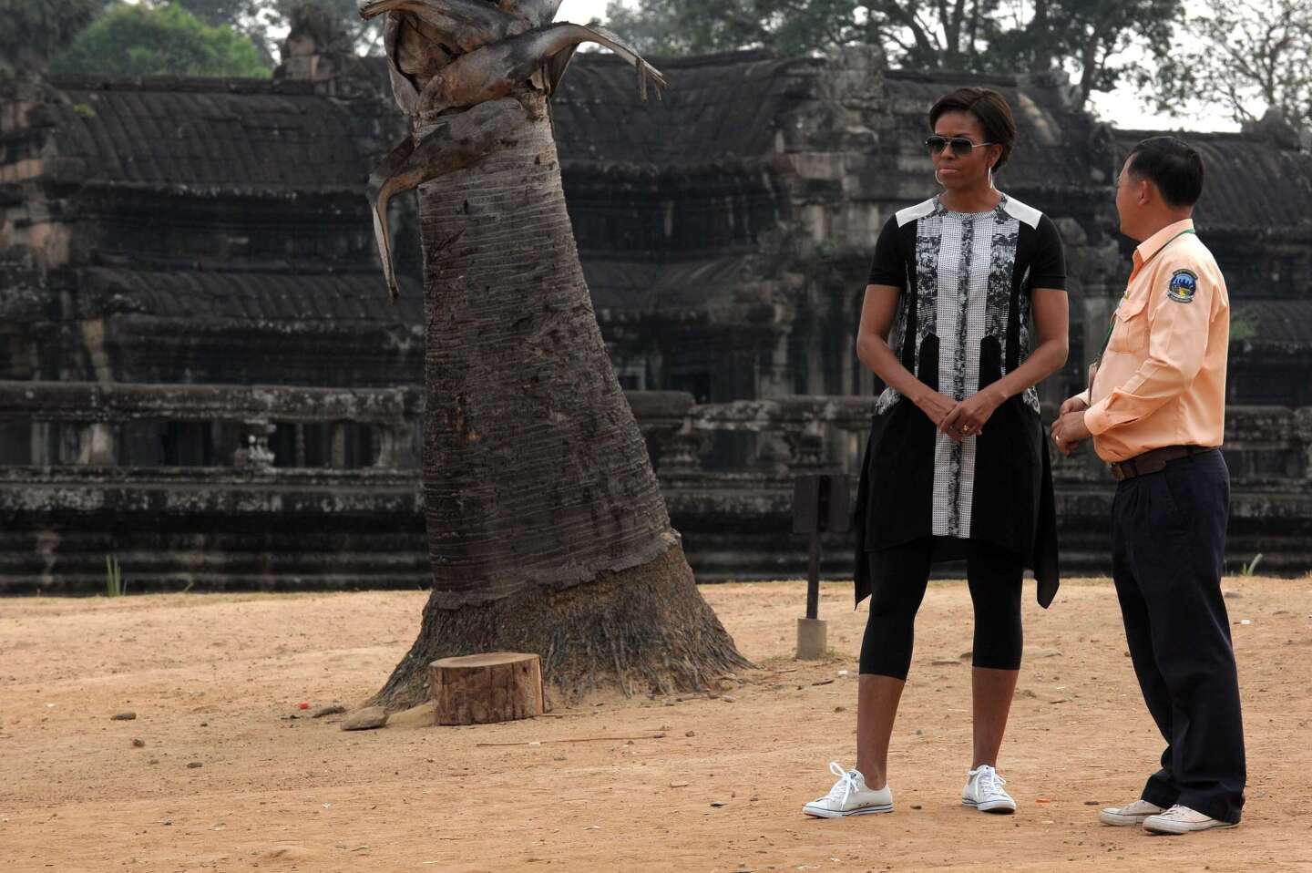 Michelle Obama listens to a Cambodian guide during her visit to Angkor Wat temple in Siem Reap province in Cambodia.
