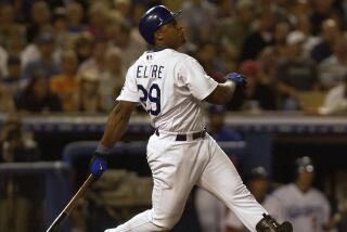 Dodgers' Adrian Beltre follows through on a home run hit off Braves pitcher Russ Ortiz at Dodger Stadium.