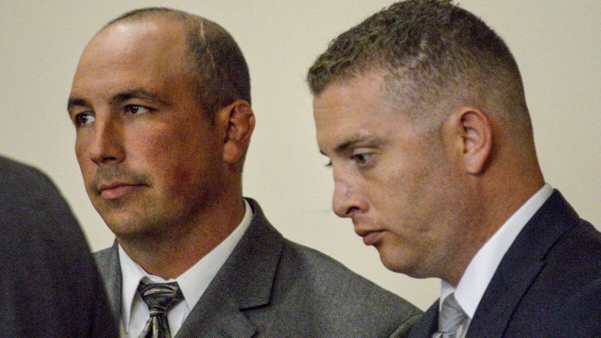 Former Albuquerque Police Det. Keith Sandy, left, and Officer Dominique Perez in court last year.