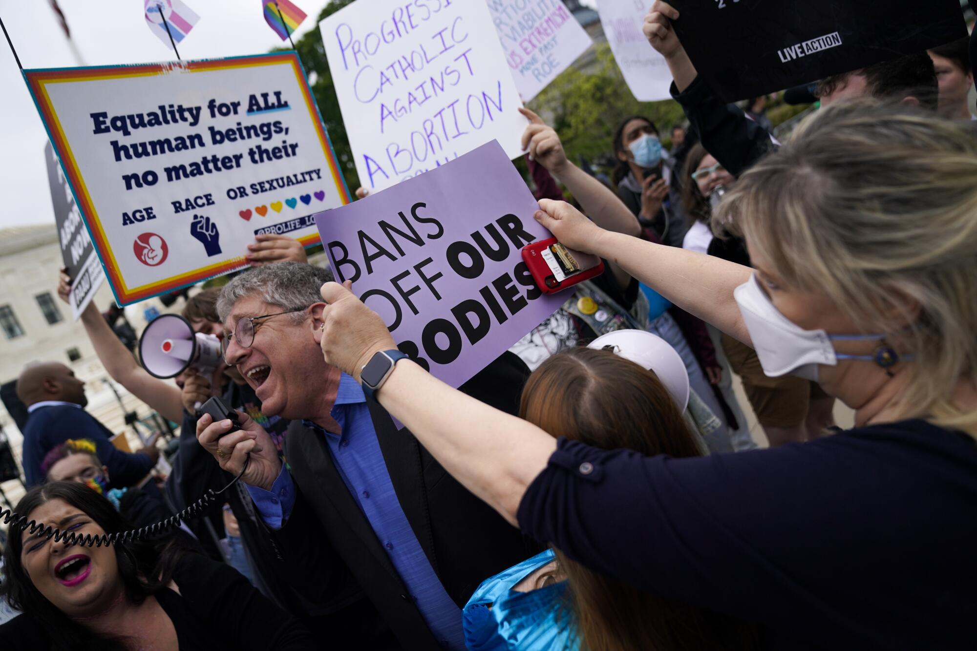 Demonstrators for and against abortion rights clash outside the Supreme Court on Tuesday.