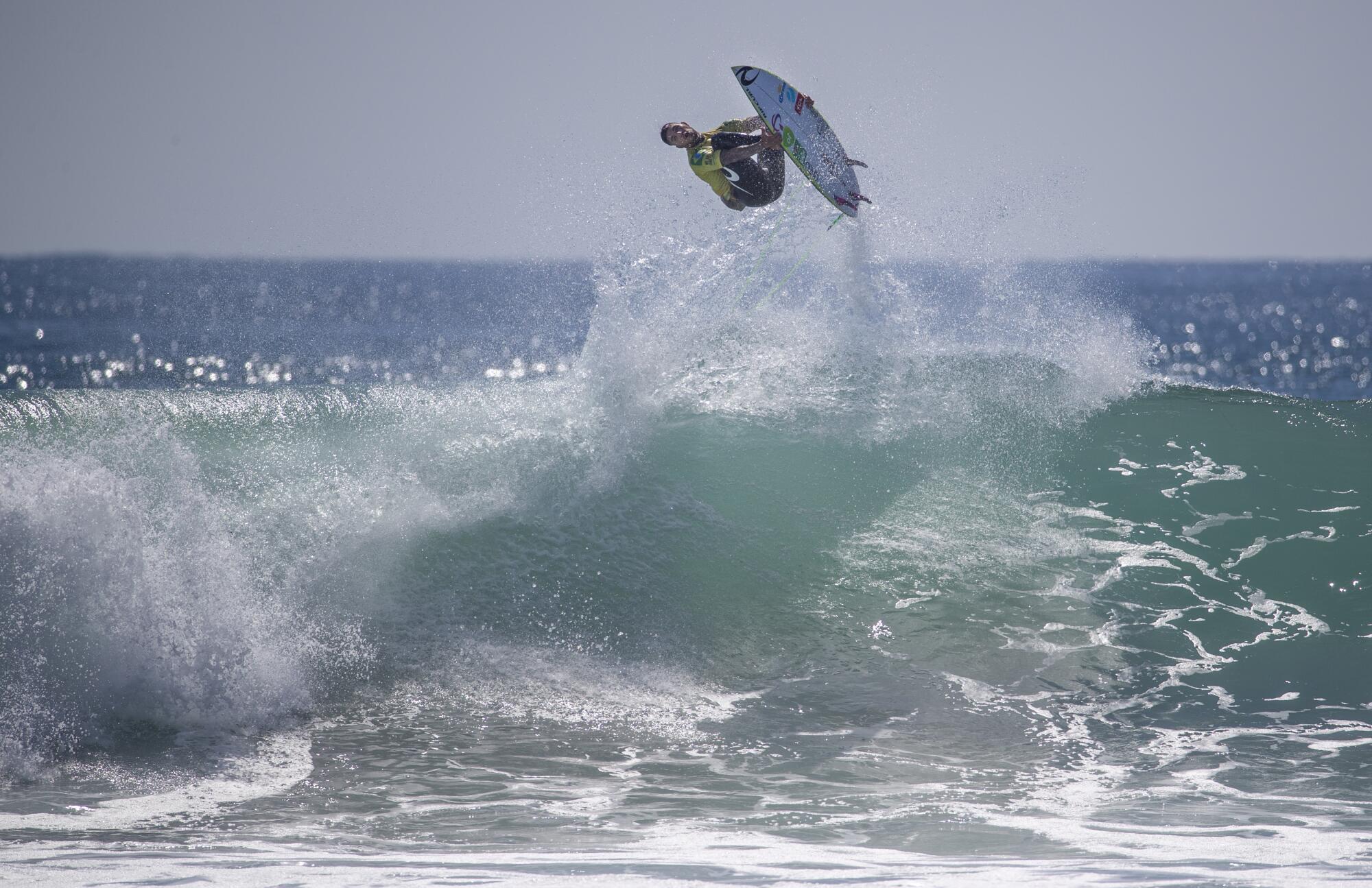 Gabriel Medina does a backflip on a big wave as he beats Filipe Toledo in the finals