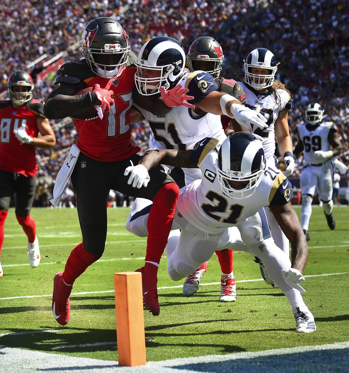 Photographs by Wally Skalij  Los Angeles Times CHRIS GODWIN of the Buccaneers beats the Rams’ Troy Reeder (51) and Aqib Talib to the end zone for a second-quarter score, part of the Tampa Bay receiver’s 172-yard, two-touchdown performance.