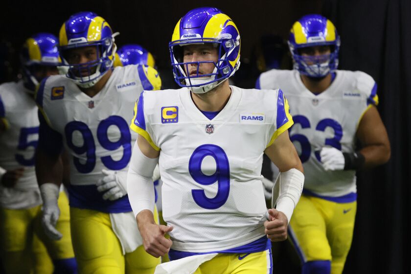 Los Angeles Rams quarterback Matthew Stafford (9) leads his team onto the field.