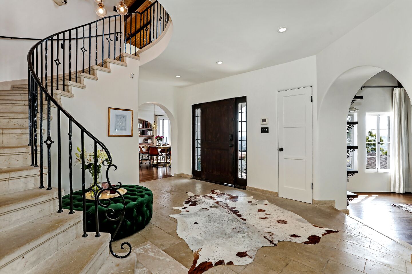 Stonework and a hand-forged staircase in the entry are original.