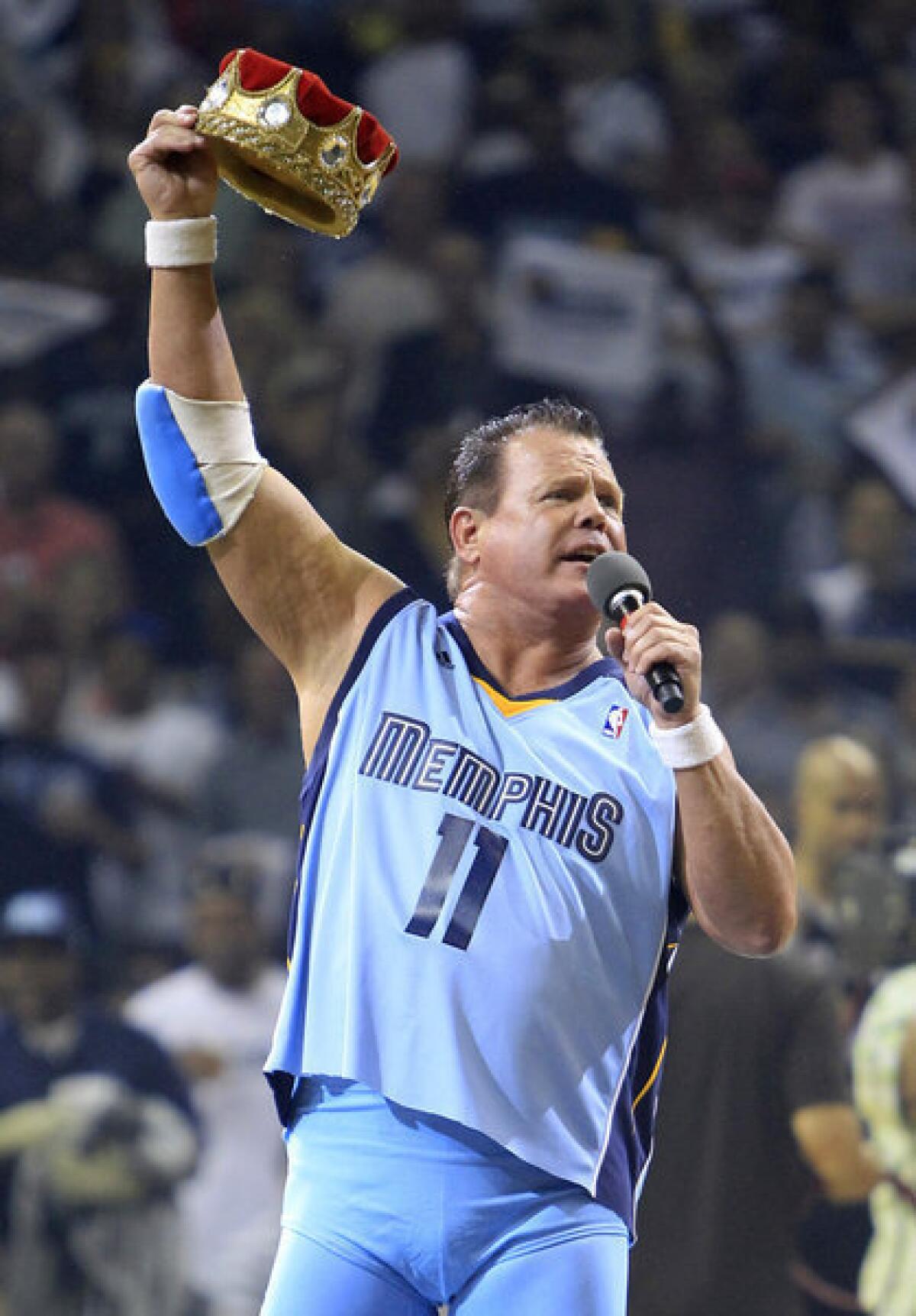 In an April 2011 file photo, Jerry Lawler gestures to fans before the start of Game 3 of a first-round NBA playoff series game between the San Antonio Spurs and the Grizzlies in Memphis, Tenn.
