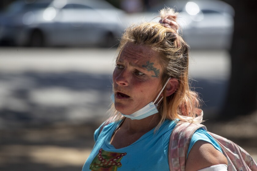 Amanda, who is homeless, speaks with the street medicine team at the Venice Family Clinic at Reed Park in Santa Monica, California.