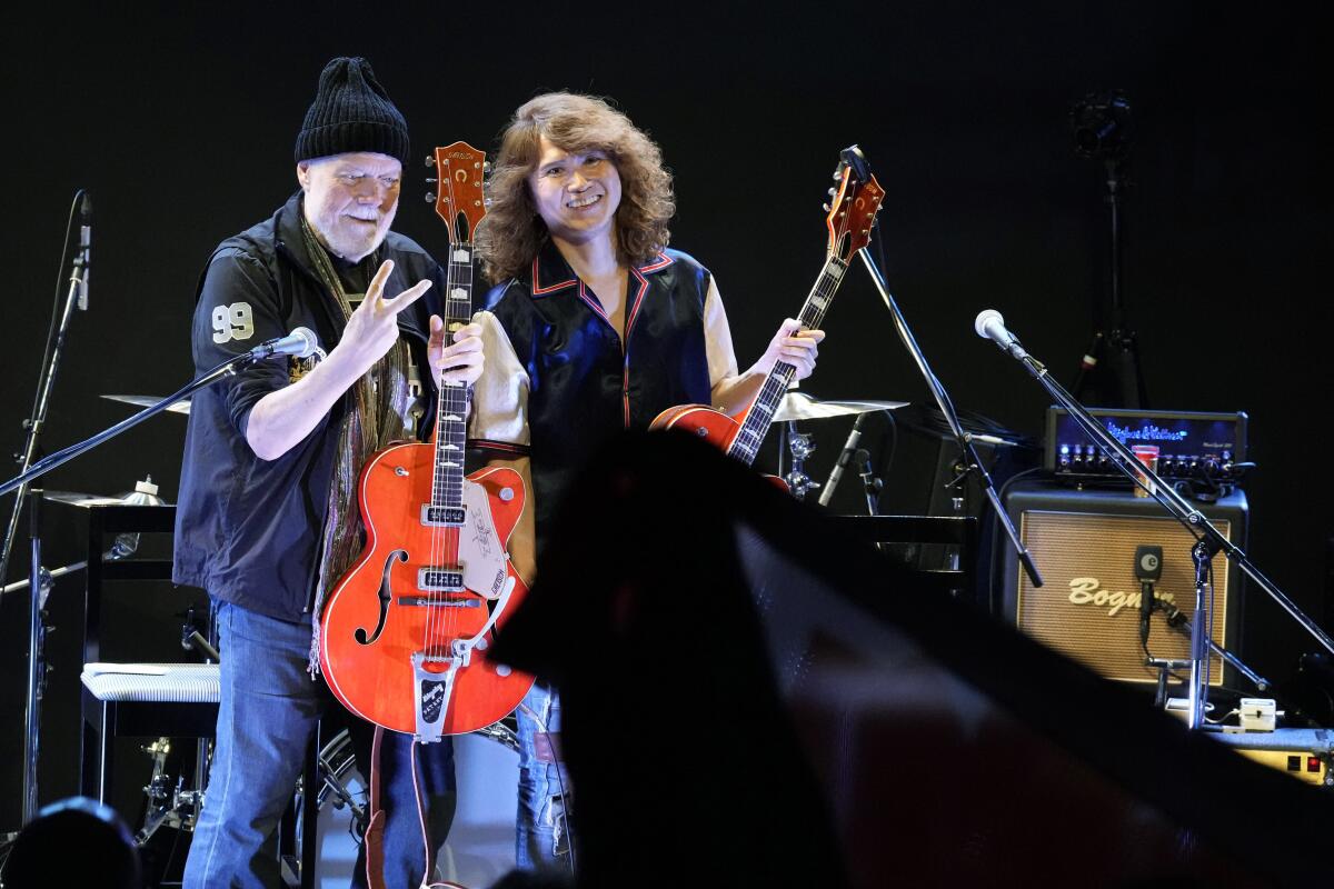 Canadian rock legend Randy Bachman, holding his long-lost Gretsch guitar in 2022.