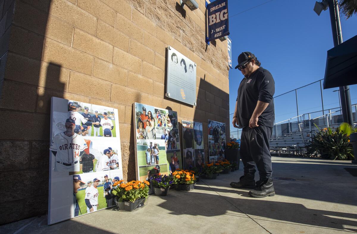 Lee Watanabe, whose brother Jourdan Watanabe died in 2009, looks at photos of the Altobelli family at OCC on Tuesday.